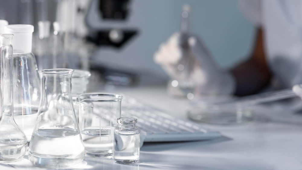 close up blurry researcher holding glassware